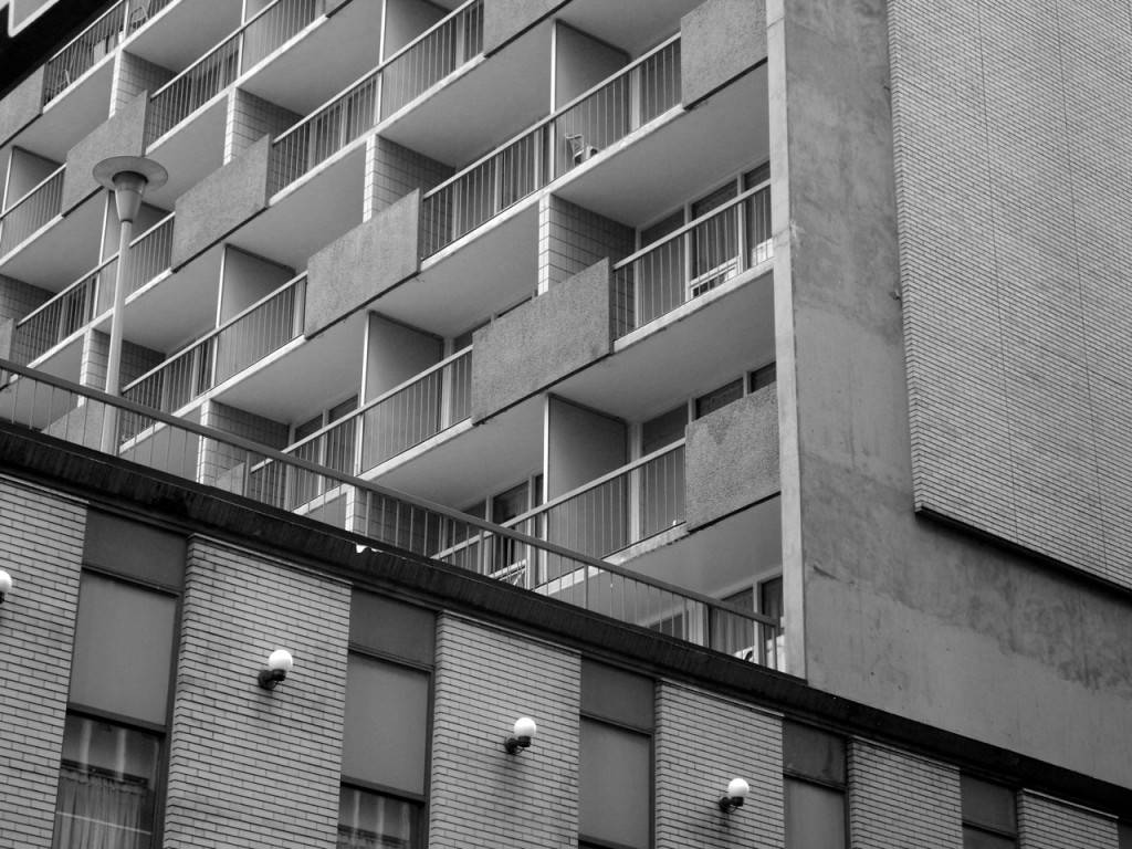 A view of the Ramada Inn in Calgary, showing the typical repetitive pattern of the balconies overlooking the pool.